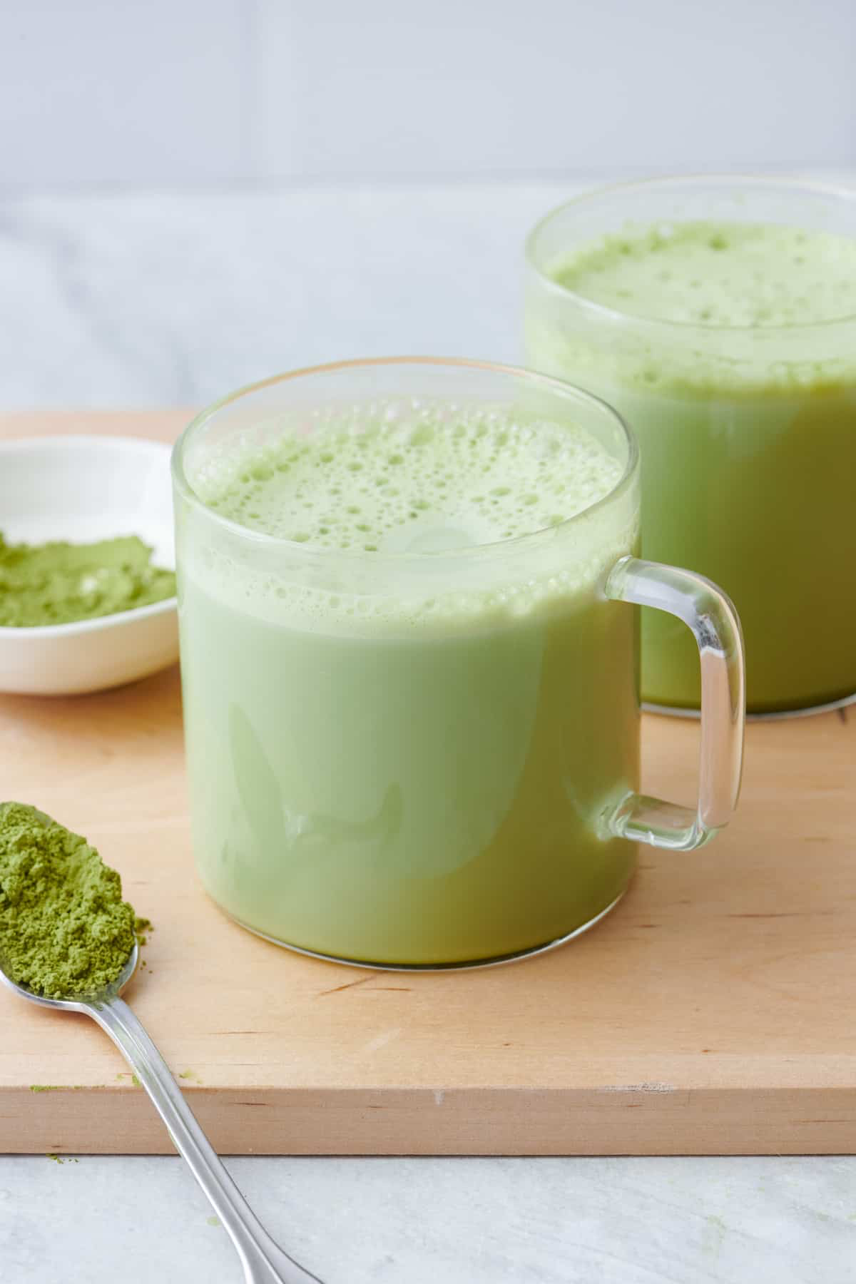 Hot matcha in a glass mug.